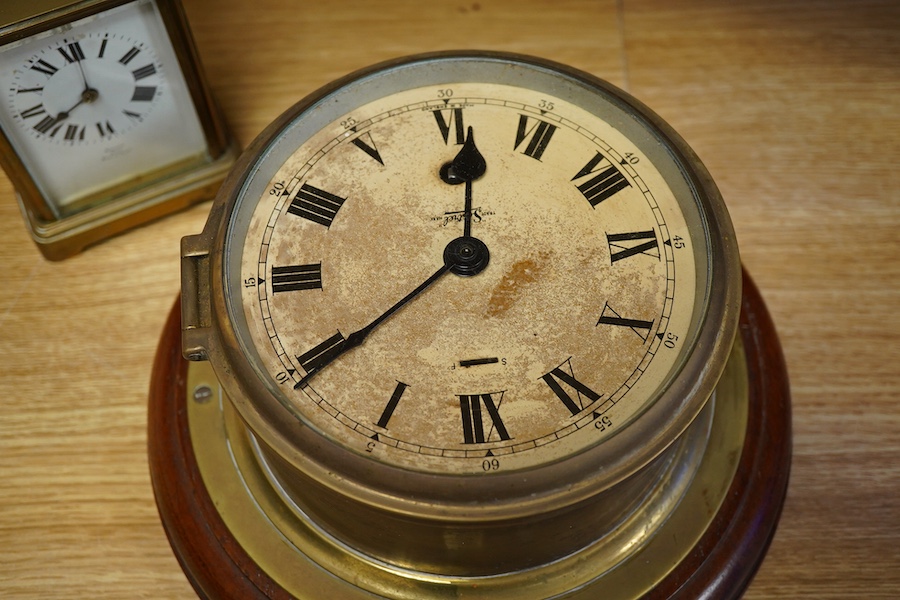 A brass bulk head timepiece and a late 19th century brass cased carriage clock, the dial inscribed Mallory Bath, made in Paris, with key